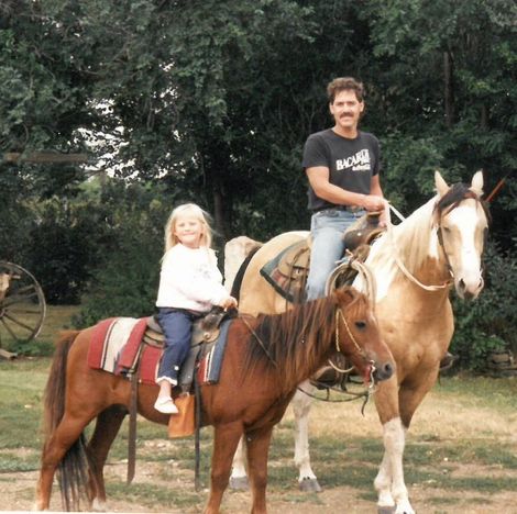 Tomi Lahren riding horse with her father