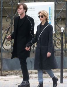 Charlie Heaton holding hands of his co-star, Natalia Dyer in Paris