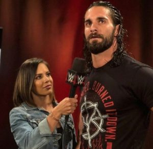 Charly Caruso looking at Seth Rollins while interviewing.
