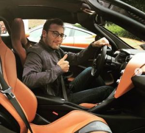 Simon sitting on his friends Mcclaren720s Car 