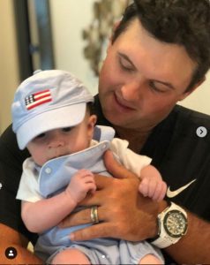 Justine Karain's second child, Barret Benjamin in the arms of Patrick Reed.