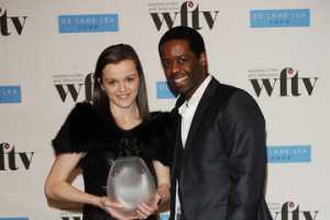 Katie Jarvis with Adrian Lester in an Award ceremony