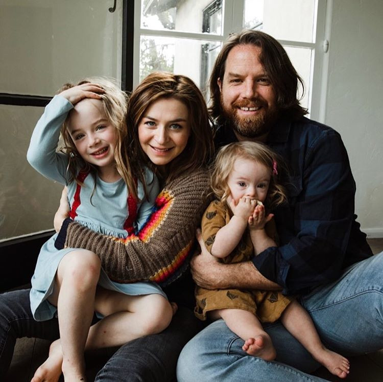 Rob Giles posing with his wife and two daughters photo