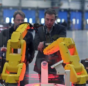 Musk observing an assembly demo at the reopening of the NUMMI plant, now known as the Tesla Factory (Fremont, California) in 2010