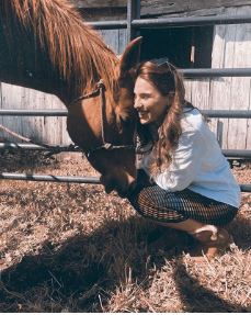 Melia Kreiling with a loving horse in Louisiana.