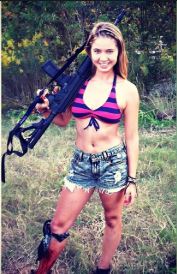 Photo of Ayla Kell with a machine gun.