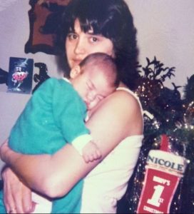 Childhood photo of Nicole Williams in her mother's arms.