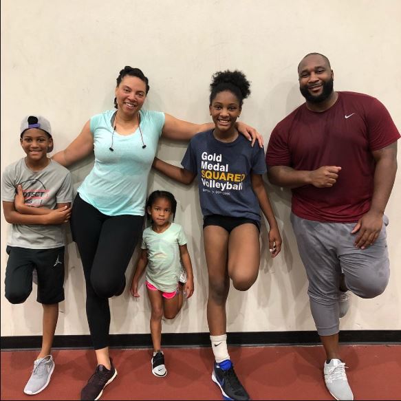 Marcus Spears with his wife and children.