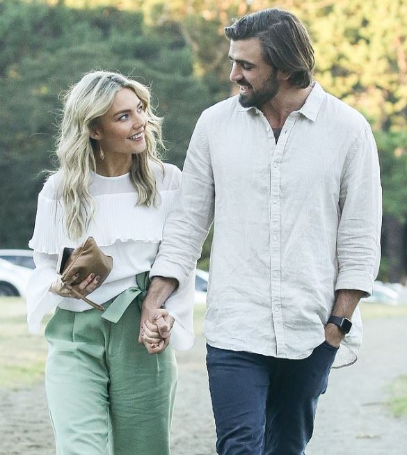 Sam Frost and her boyfriend, Dave Bashford while holding hands.