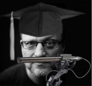 Photo of Steve Blum while wearing a graduate hat.