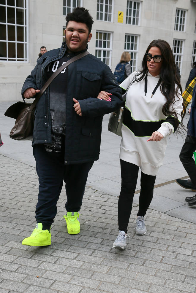 Dwight Yorke and her mother walking in the street