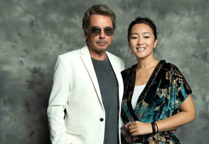 Jean-Michel Jarre with his current wife, Gong Li in a pose during the opening night of the COLCOA French Film Festival at the Directors Guild of America Theater in Los Angeles, California, on 23rd April 2018.