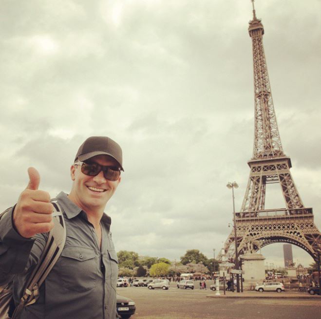 Cyril Chauquet taking photo aside Eiffel Tower in Paris, France.