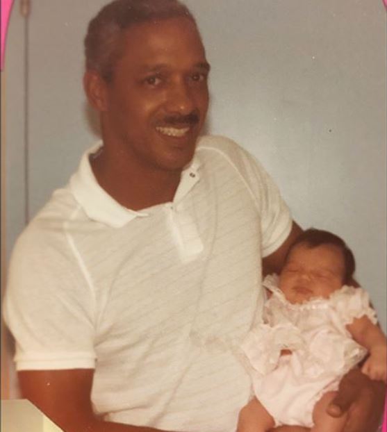 Childhood photo of Rachel Smith in her father's arm.