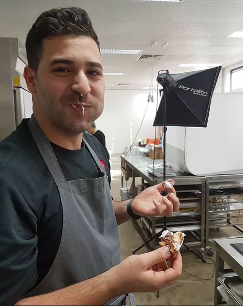 Adriano Zumbo eating a piece of pastry.