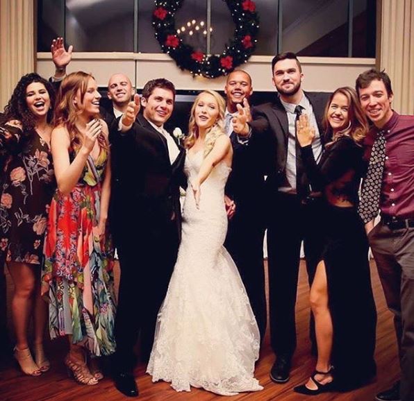 Kathryn Wahl and her husband, Hunter Parrish celebrating their wedding ceremony with their friends.