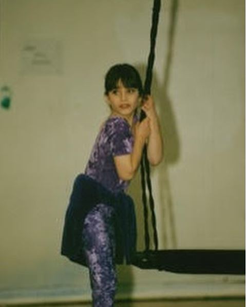 Childhood photo of Ariana Gradow while practicing gymnastic.