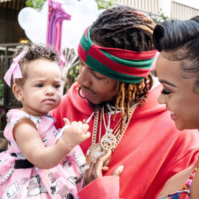 Zaveira Maxwell in her father's arm aside her mother at her 4th birthday party.