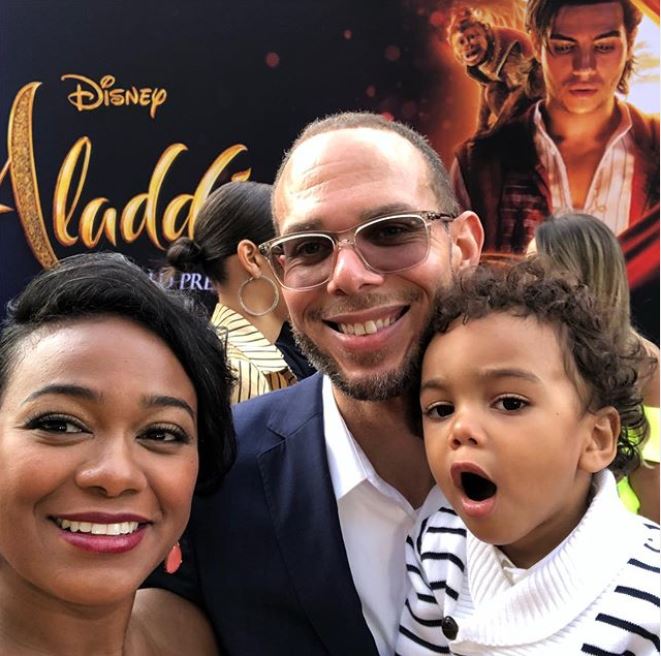 Edward Aszaard Rasberry in his father's arm while her mother taking a selfie at the premiere of Aladdin.