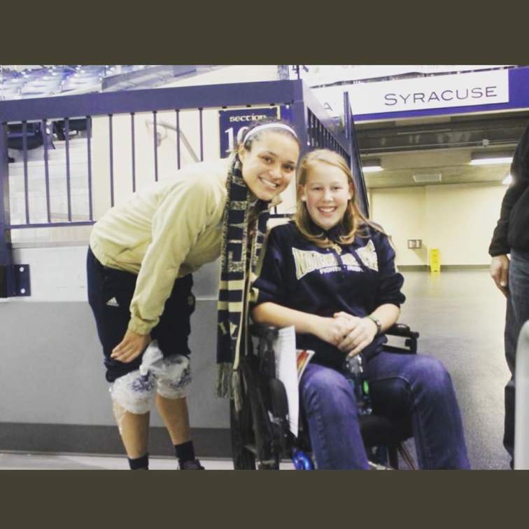 Kayla McBride taking a photo with her lovely fan.