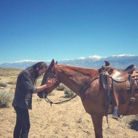 Avi Kaplan is showing his love for a horse in Bishop, California.