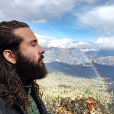 Avi Kaplan is enjoying the beautiful scenery with a flowing rainbow.