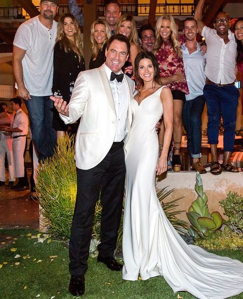 Mark Steines (left) with his wife Julie Steines (right) at their wedding with their guests at the back