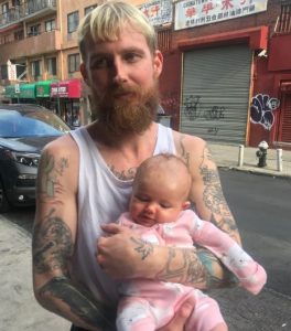 Adam Moonves holding his daughter, Ari