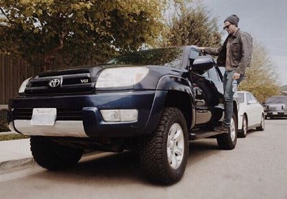 Chris McNally Standing in his brand new Toyota V4 bought in an expensive rate