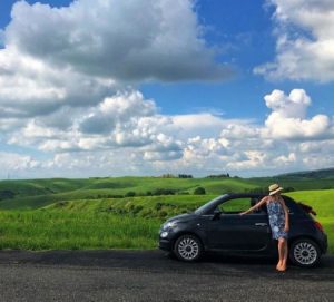 Tegan Moss along with her black fiat 500 car