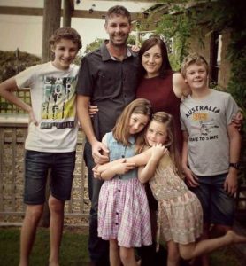 Wife, Kathy Parker and husband, Paul along with their four children picturing a family photo