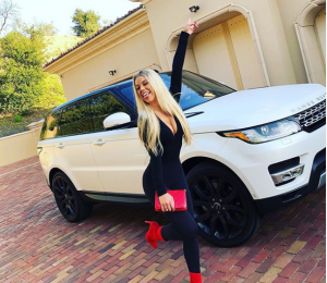 Kaylyn posing with her new car a Range Rover