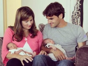 Mirka and her husband Roger holding their just borns twins son.