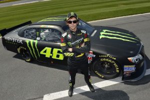 Valentino posing in front of his car.