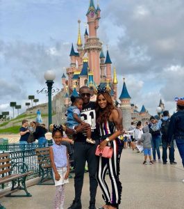 Steve with his wife and daughters standing infront of Disneyland, Paris.