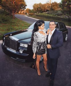 Manny with his wife in front of brand new Rolls Royce.