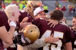 Al Minnaert hugging Eric Popovich after winning against Portage at Otto Breitenbach Stadium