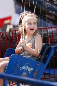 Bear enjoying swing in the park.