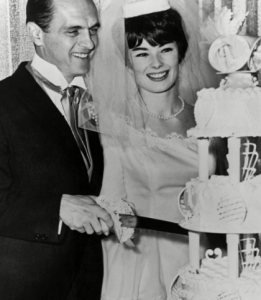 Newly wed Newhart couple cutting their wedding cake. 