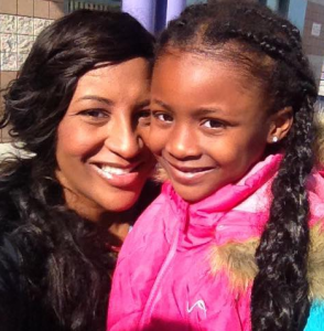 Shaya Bryant with her daughter who is wearing a pink jacket