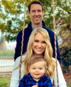 Mike Whickham and his Wife Heidi Watney and son Jax who are sitting on a swing.
