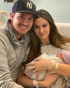 Carter with her husband and newly born baby daughter.