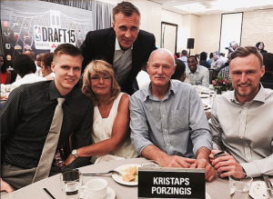 Kristaps Porzingis with his parents and two brothers in a party.