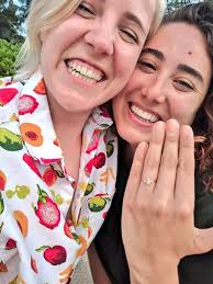 Ella with her fiance, Hannah Hart showing her engagement ring.